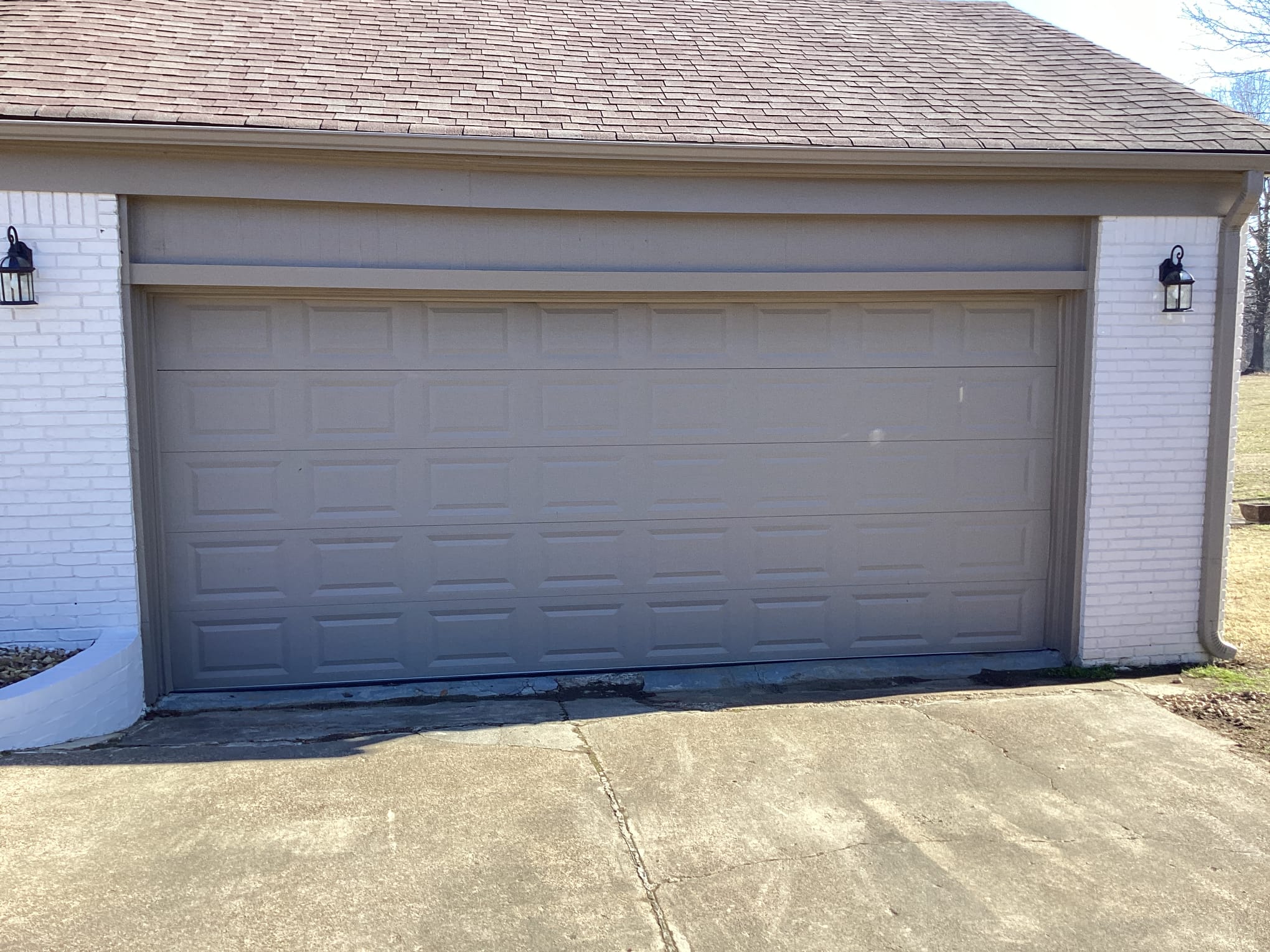 Finished gray raised-panel garage door installed on a Greater Memphis home