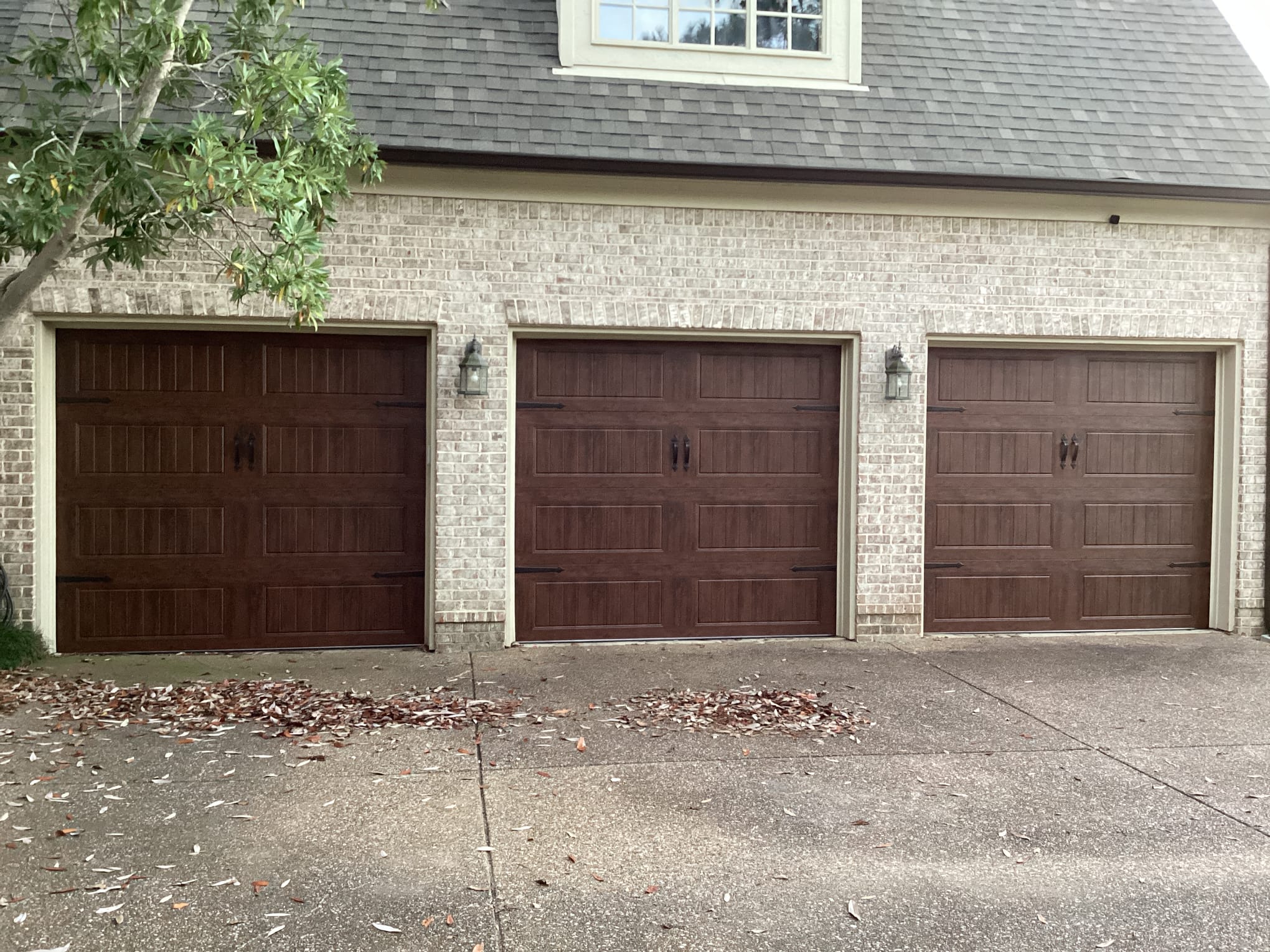 Three finished carriage-style garage doors installed by Lift Doctors in Greater Memphis