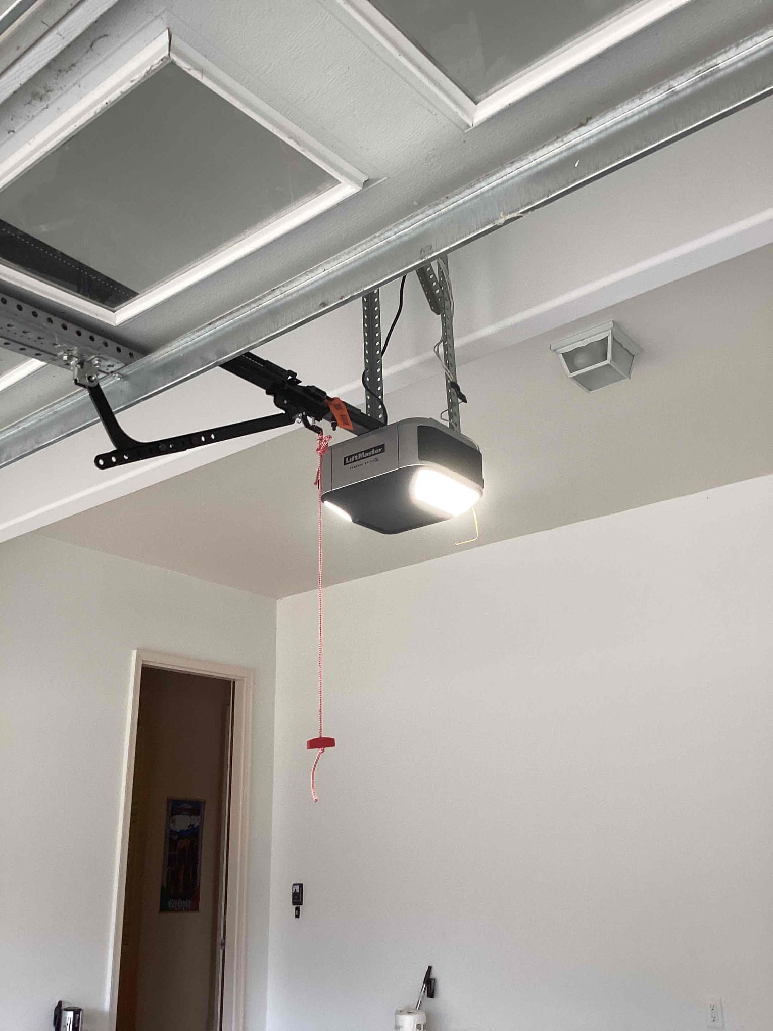 Garage door opener and lifting hardware checked during a maintenance visit