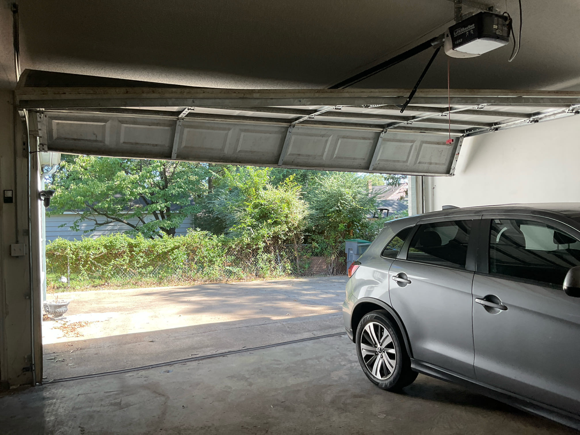 Garage door requiring urgent repair inside a Greater Memphis garage